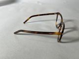 a pair of glasses sitting on a white surface