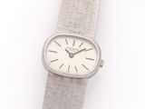 an image of a silver wrist watch with a white face