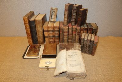 many old books sitting on a table next to each other