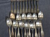 a lot of silver spoons and spoons on the table
