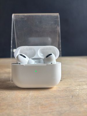 an apple airpods are sitting in a clear case on a wooden table