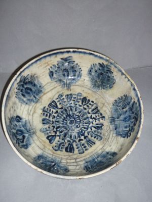 a blue and white bowl with a circular design on it