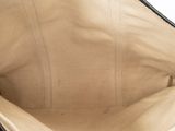 the inside of a black and tan purse with a zipper