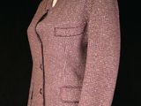 a pink jacket on a white mannequin on a black background