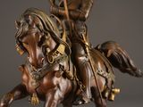 bronze statue of a man on a horse with a staff