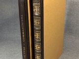a brown book with a black cover sitting on top of a table