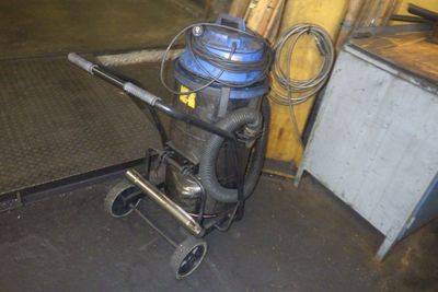 a picture of a vacuum on a cart in a garage