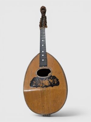 an old wooden guitar with a black and white design on the neck