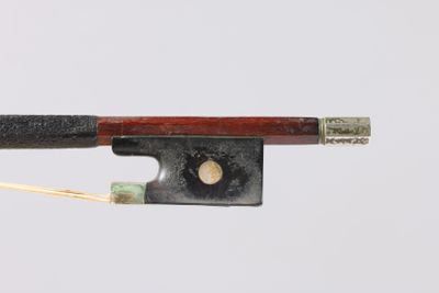 an old violin bow with a wooden handle on a white background