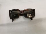 sunglasses on a table with a white table cloth and a pair of glasses
