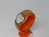 an orange bracelet watch with a gold band and a white face