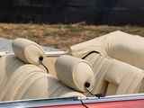 a close up of a red convertible car with beige leather seats