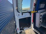 a white van with the door open and a dog in the back