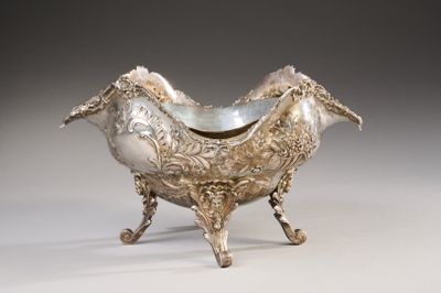 an ornate silver bowl with a bird shaped handle on a stand