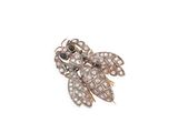 a close up of a gold and diamond broochle on a white background