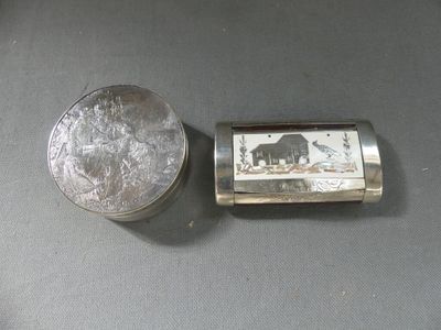 a small silver box with a picture of an elephant on it