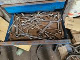 a lot of wrenches in a box on the floor