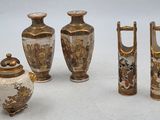 four vases and a teapot sitting on a table