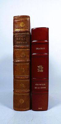 two books sitting next to each other on a white surface