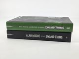 two books are stacked on top of each other on a white surface