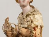 a statue of a woman holding a bird in her hand