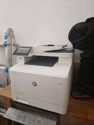 a white printer sitting on top of a wooden table