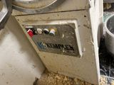 a dirty machine that is sitting in a dirty room