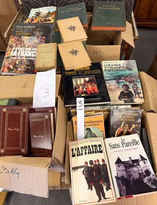 boxes of books are stacked on top of each other in a room
