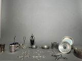 a table with a lot of silver items on it