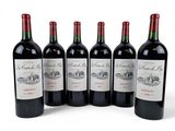 six bottles of red wine are lined up in a row