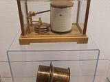 a glass display case with a clock inside of it