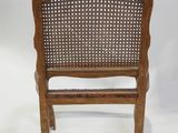 an old wooden chair with a woven back and seat
