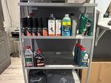 a metal shelf with various items on it in a room