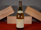 a bottle of wine sitting on a table next to two wooden boxes