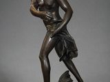 statue en bronze représentant une femme tenant un bébé sur un rocher