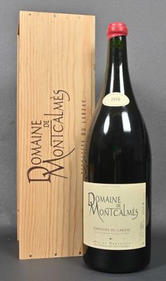 the bottle of wine is next to a wooden box