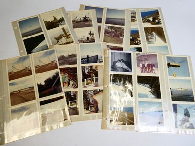 a lot of old photos of airplanes on the table