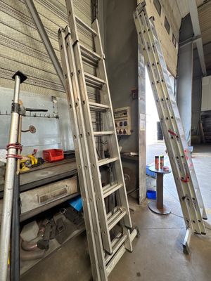 two ladders that are leaning up against the wall
