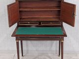 an image of a small desk with a green top and gold trim