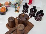 a wooden tray with salt and pepper shakers on it