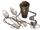 several spoons and spoon spoons are sitting next to a cup