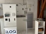 an image of a kitchen with a refrigerator and a table