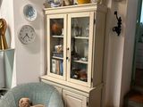 a teddy bear sitting on a chair in a living room