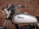 a motorcycle that is parked in front of a brick wall