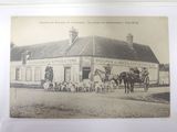 a black and white photo of a horse and buggy outside of a building