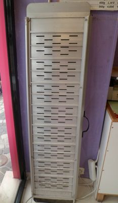 a rack with a bunch of items on it in front of a purple wall