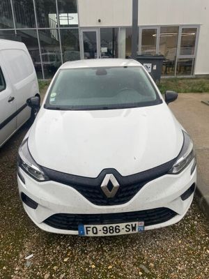 the front of a white car parked in front of a white van