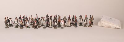 a lot of figurines that are lined up on a table