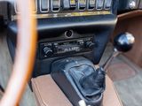 a car dashboard with a gear box and a steering wheel