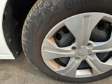 a close up of a tire on a white car